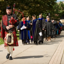 Faculty in robes marching