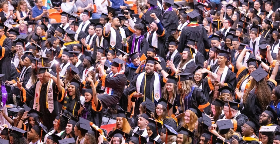 students in cap and gown at commencement