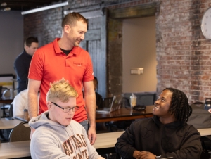 Paul Perry talking to two Buffalo State students